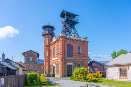 Sevcinsky Mine, located in Brezove Hory near Pribram, showcases its historic architecture and mining equipment under clear blue skies. The site reflects rich mining heritage and industrial history.の写真素材