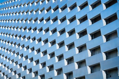 The facade of Amager Bakke in Copenhagen displays a unique pattern of blue and white elements, emphasizing its innovative design. This structure stands out in Denmarks architectural landscape.の写真素材