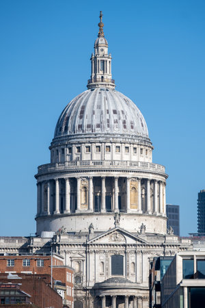 The magnificent dome of St. Pauls Cathedral rises majestically against a clear blue sky. This iconic landmark showcases Londons rich architectural history and attracts many visitors daily.の写真素材