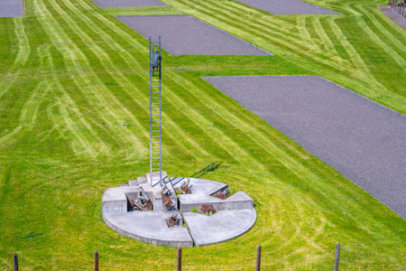 A memorial dedicated to the victims of communism stands in the former prison complex in Lesetice, Czechia. The well-kept grounds feature cut grass and orderly pathways, symbolizing remembrance.の写真素材