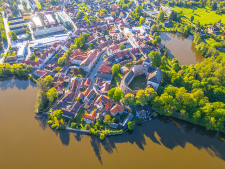 Discover the beautiful landscape of Rozmital pod Tremsinem in Czechia, featuring a historic castle surrounded by a quaint town and lush greenery by the riverside.の写真素材