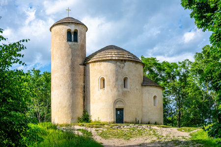 This historic Romanesque rotunda, dedicated to Saint George, stands majestically atop Rip Mountain in Czechia. Surrounded by lush greenery and under a bright sky, it invites exploration.の写真素材