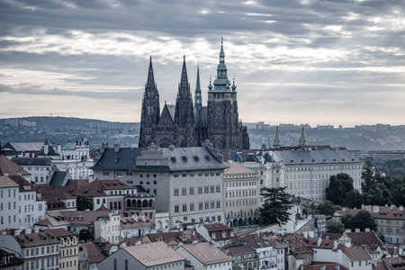 The early morning sun casts a golden hue over Prague Castle, illuminating its towers and highlighting the historic architecture of the city. A perfect start to the day in Prague.の写真素材