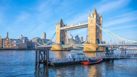 Morning at Tower Bridge reveals a stunning view with clear skies and soft light reflecting on the Thames River. The iconic structure stands majestically against the London skyline.の写真素材