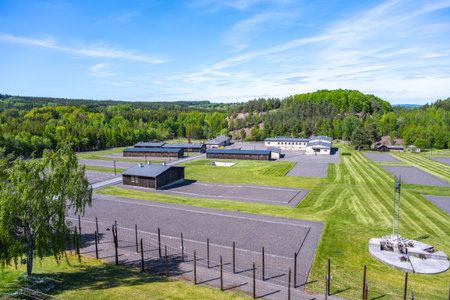 This memorial in Lesetice, Czechia, commemorates victims of communism at a former prison complex. Lush greenery surrounds the site, highlighting its somber history and significance.の写真素材
