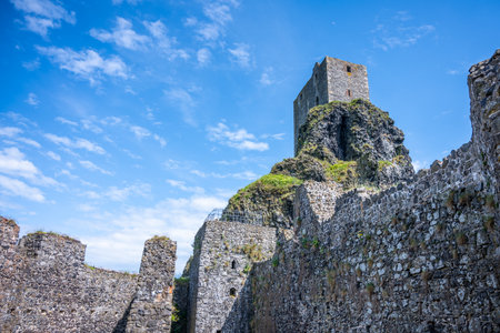 Trosky Castle Ruins rise dramatically in the Bohemian Paradise region of Czechia. Visitors can admire the ancient stone walls and panoramic views on a sunny day with blue skies.の写真素材