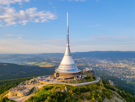 At sunset, Jested Mountain Hotel stands out with its modern architecture. Located in Liberec, it offers stunning views of the surrounding mountains and valleys bathed in evening light.の写真素材