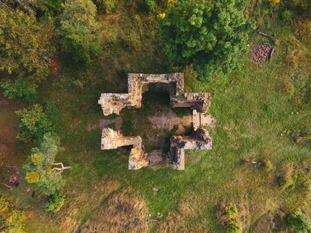 Aerial view of the ruins of the Chapel of the Exaltation of the Holy Cross in Bristev. Surrounded by nature, the remains feature stone walls and a cross-shaped layout.の写真素材