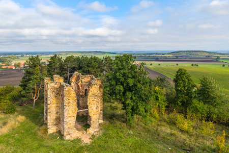 Explore the ancient ruins of the Chapel of the Exaltation of the Holy Cross in Bristev. The remnants rise amid lush greenery and pastoral fields, showcasing a blend of history and nature.の写真素材