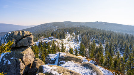Pytlacke Rocks in the Jizera Mountains feature a stunning winter landscape. The sunny morning light...