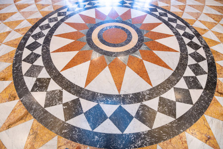 The mosaic pavement features a radial design with geometric shapes. It is located in the Pantheon of...