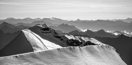 Daring climbers navigate the sharp and steep summit ridge of Piz Palu, surrounded by breathtaking...