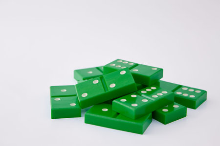 Dominoes in plain background, large pile of dominoes