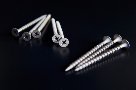 many black screws on a black backgroundの写真素材