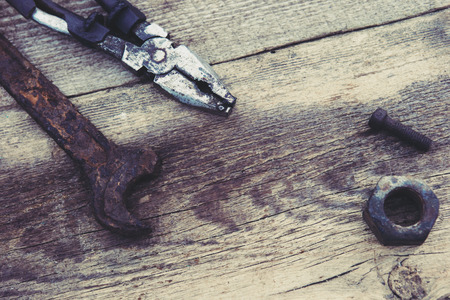 rusty old tools on old wooden boardsの写真素材