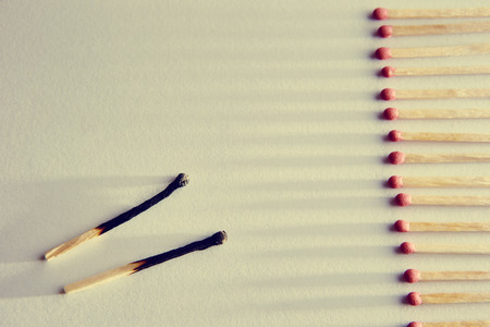 burned matches on a white background, a bunch of matches. and long shadowsの写真素材