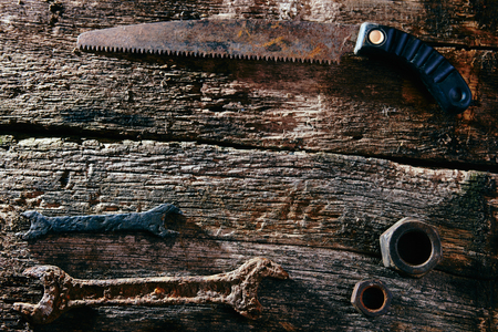 rusty old tools on old wooden boardsの写真素材