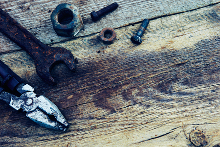 rusty old tools on old wooden boardsの写真素材