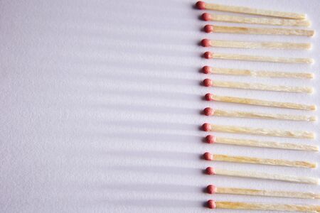 burned matches on a white background, a bunch of matches. and long shadowsの写真素材