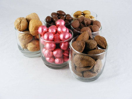 Candy and nuts displayed against an off-white background.