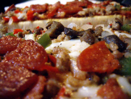 A close-up shot of cooked pizza toppings.の写真素材