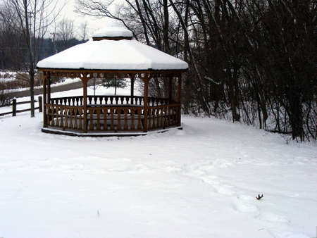 A gazebo covered in winter snow.の写真素材