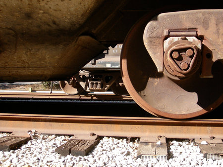 Train wheels close up. Overexposed to give the sense of age and heat.
