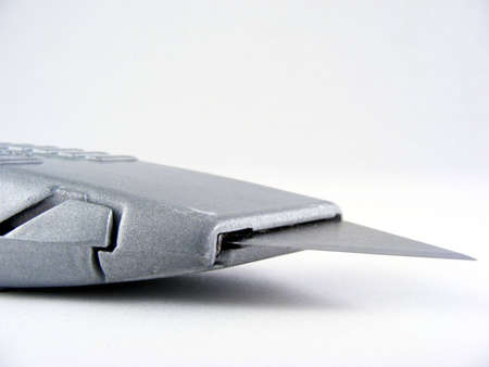 An utility knife against an off-white background.の写真素材