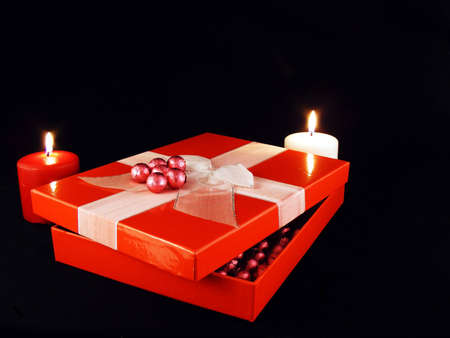 A valentines gift with candles against a black background.の写真素材