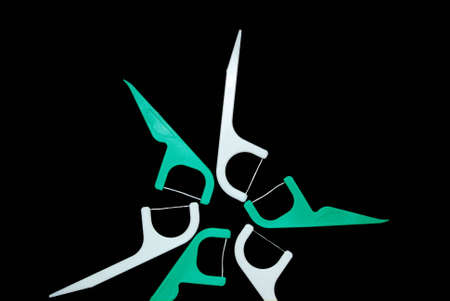 Six dental floss holders arranged in a circle.の写真素材