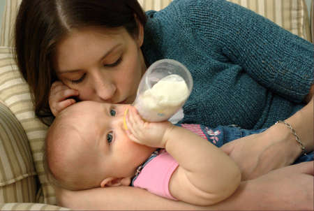 A young mother interacting with her child within their home.の写真素材