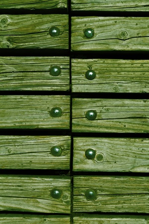 washed green wooden texture background with rivets close upの写真素材