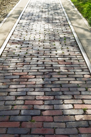 old rail track paved with cobble stonesの写真素材