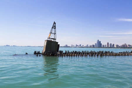 old concrete buoy on breakwater with Chicago skylineの写真素材