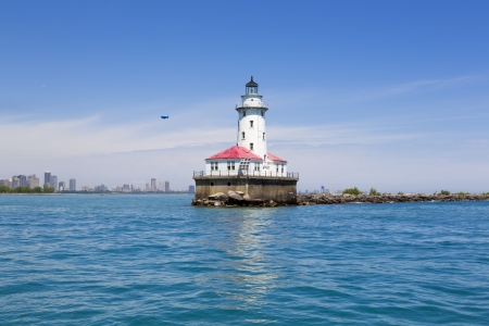 Chicago harbor lighthouse in the summer with city skyline and airshipの写真素材