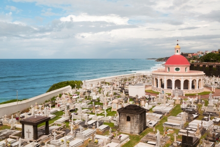 Historic waterfront Santa Maria Magdalena de Pazzis cemetery in San Juan, Puerto Rico with cloudy skyの写真素材