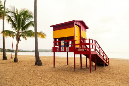 Classic lifeguard station on empty tropical beach on cloudy day in low seasonの写真素材