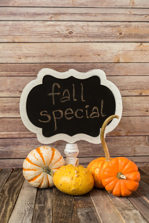 Chalkboard sign and decorative fall gourdsの写真素材