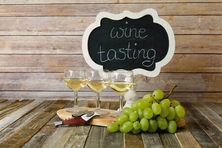 White wine flight with chalkboard sign and grapesの写真素材