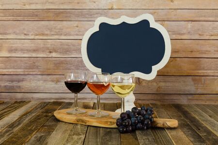 Wine flight with blank chalkboard sign and grapesの写真素材