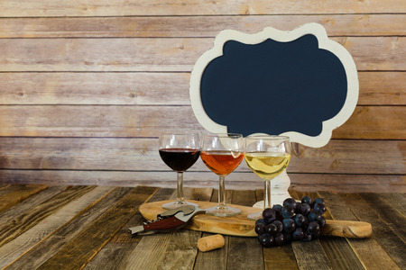 Wine flight with blank chalkboard sign and grapesの写真素材