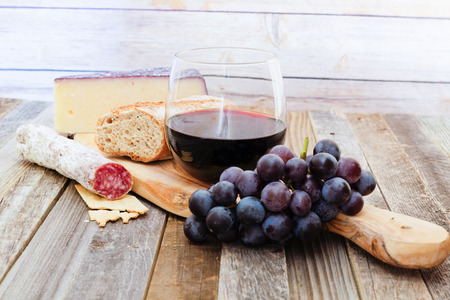 Glass of red wine with appetizersの写真素材