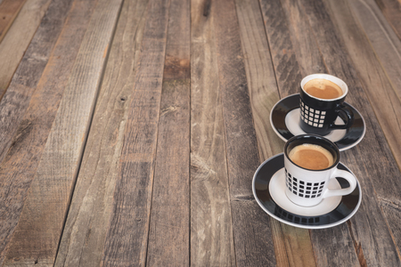 Two small espresso coffee cups on wooden background. Side view.の写真素材