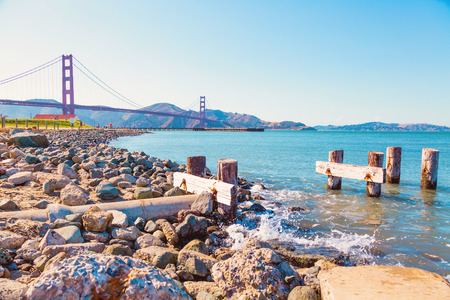 People running on sunny weekend by Golden Gate Bridge in San Francisco, Californiaのeditorial素材