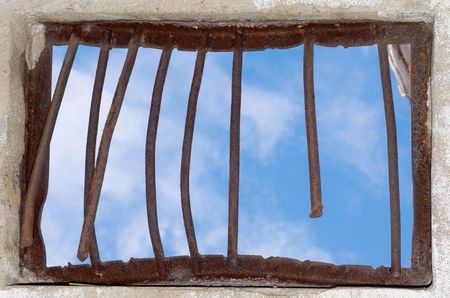 Old window closed by a rusty latticeの写真素材