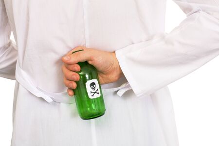 Hand in white overall with green bottle of poison on a white backgroundの写真素材