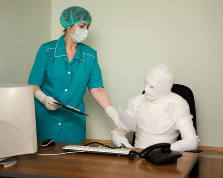 The patient similar to a mummy and the doctor, at officeの写真素材