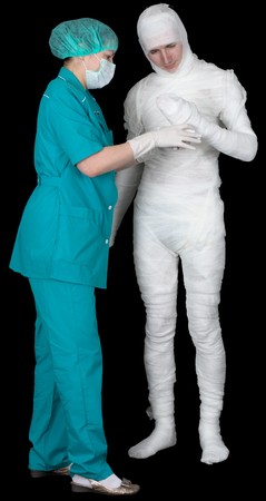 Man in bandage and nurse on black backgroundの写真素材
