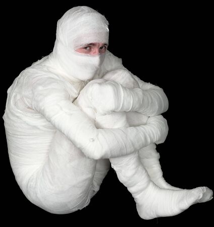 Egyptian mummy emo sitting on the black backgroundの写真素材