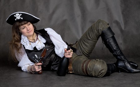 Drunken girl - pirate on black with pistol and bottleの写真素材